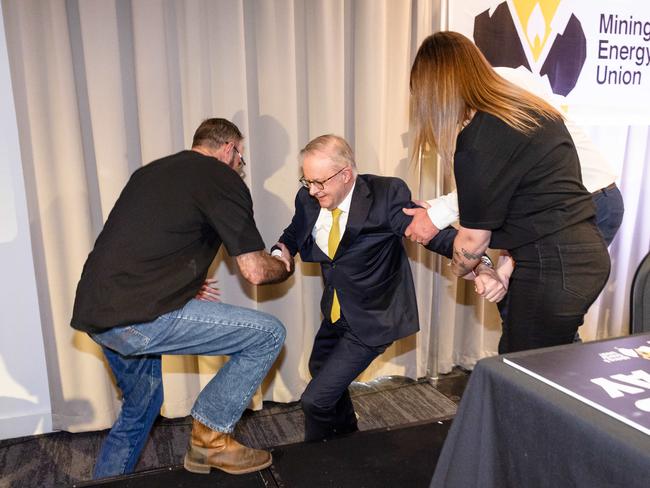 The PM being helped to his feet after the fall. Picture: Jason Edwards
