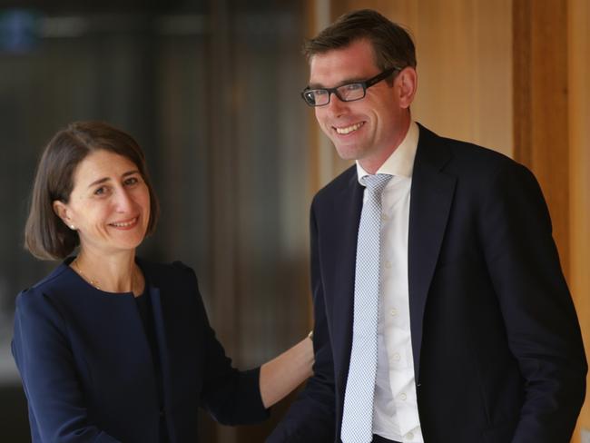 Newly elected Premier Gladys Berejiklian shakes hands with new Treasurer Dominic Perrottet. Picture: Toby Zerna