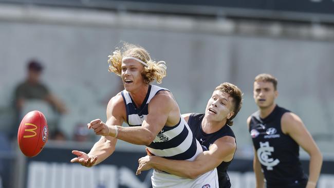 Sam De Koning shoots out a handball. Picture: Michael Klein