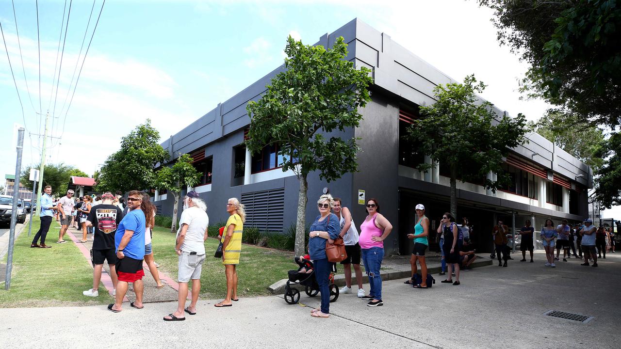 Lines of people wait at Southport Centrelink. Picture: Adam Head.