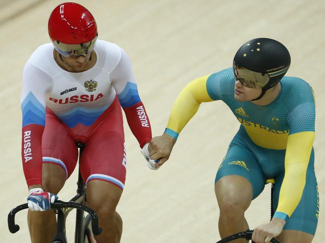 Russia's Denis Dmitriev (L) shakes hands with Australia's Matthew Glaetzer after beating him in the Men's Sprint final track cycling event at the Velodrome during the Rio 2016 Olympic Games in Rio de Janeiro on August 14, 2016. / AFP PHOTO / Odd ANDERSEN