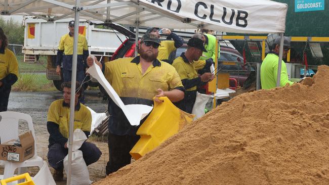 Locals flocked to sandbagging stations as Cyclone Alfred approaches the Gold Coast. The Reedy Creek depot staff worked tirelessly but people had a two hour wait and the queue snaked around the surrounding streets. Picture Glenn Hampson