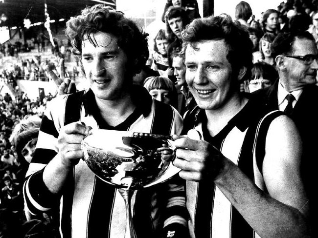 Glenorchy playing-coach Peter Hudson holding the 1975 premiership cup with Glenorchy captain Darryl Sutton.