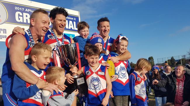 Blair Harvey (left), Shane and Brent Harvey celebrate North Heidelberg's 2017 NFL premiership. Picture: Tim Michell.