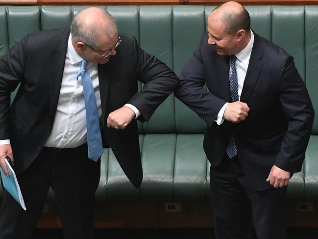 Prime Minister Scott Morrison says ‘hello’ to Treasurer Josh Frydenberg with social distancing measures. Picture: Sam Mooy/Getty