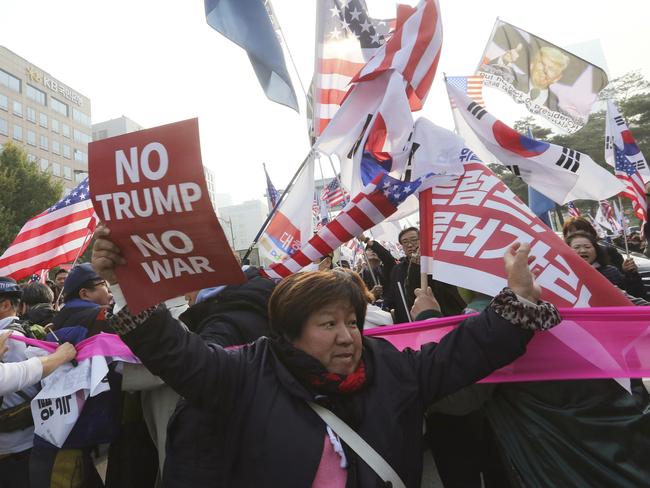 Members of ‘No Trump Coalition’ front clash with pro-US protesters as they wait for the president’s arrival. Picture: Ahn Young-joon/AP