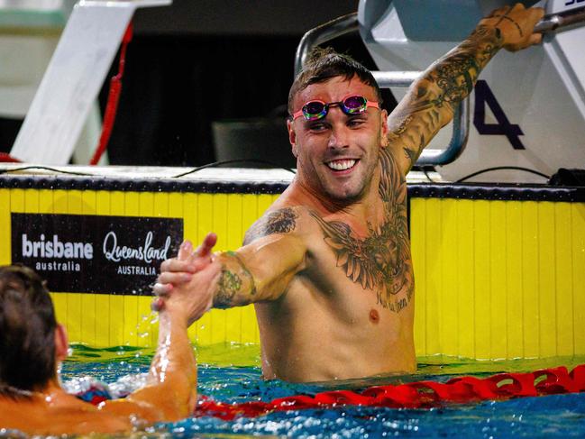 Australiaâs Kyle Chalmers (R) reacts following the men's 100m freestyle final during the Australian Swimming Trials at the Brisbane Aquatic Centre on June 13, 2024. (Photo by Patrick HAMILTON / AFP) / -- IMAGE RESTRICTED TO EDITORIAL USE - STRICTLY NO COMMERCIAL USE --