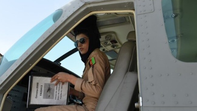 TO GO WITH AFGHANISTAN-UNREST-WOMEN-AVIATION BY ANUJ CHOPRA In a picture taken on April 26, 2015, Afghanistan's first female pilot Niloofar Rahmani, 23, sits inside a fixed-wing Afghan Air Force aviator aircraft in Kabul. With a hint of swagger in her gait, Afghanistan's first female pilot since the ouster of the Taliban is defying death threats and archaic gender stereotypes to infiltrate an almost entirely male preserve. AFP PHOTO / SHAH Marai