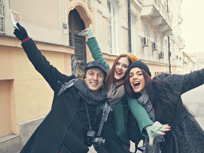 Happy Tourists Enjoying The City And Posing For Photo