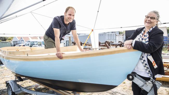 Ryan Chadwick, one of nine North West Coast School of Boat Building alumni who built the Haven 12 1/2 designed by Joel White, with school executive director Betsy Davis. Picture: EDDIE SAFARIK