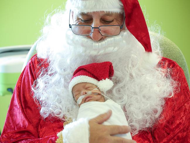 Joan Kirner Womens and Childrens Hospital Christmas prem baby stories.  PJ NG is held by Santa during Santas rounds of the ward in HDU section of Newborn Services.BoyParents Vanessa and Paz NgDOB: 19/10/24Gestation: 27 weeks, 1 dayBirth weight: 740g                                                            Picture: David Caird