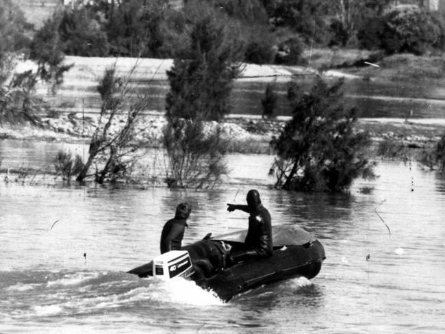 Police divers search the Nepean River near Penrith in 1975 for the body of missing heiress and journalist Juanita Nielsen.