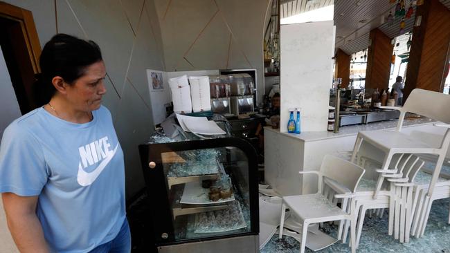 An Israeli woman stands at a restaurant that was attacked the previous night in Israel's Mediterranean city of Bat Yam on May 13. Picture: Gil Cohen-Magen/AFP