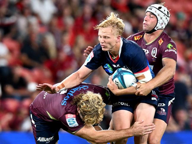 Carter Gordon of the Rebels takes on the defence of the Reds. Picture: Getty Images