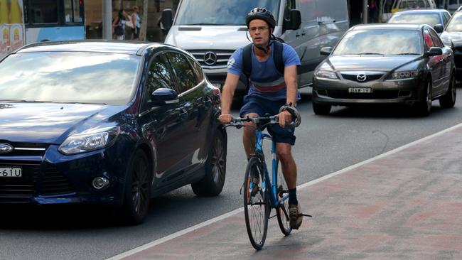 Pic of cyclists on Oxford st. In 50k zone.New laws with Cars and Bikes, Cars must give 1metre to any bikes . Fines for an offence like riding a bike without an approved helmet will rise from $71 to $319, and riding through a red light will go up to $425 (from $71). Not stopping at children or pedestrian crossings will go up by the same amount, while fines for most other bicycle rider offences (including cycling without a bell) are increasing from $71 to $106. new law new rule requiring drivers to leave either 1m or 1.5m (dependent on speed limit of road) when passing cyclists, and carrying a $319 fine and two demerit points for drivers.