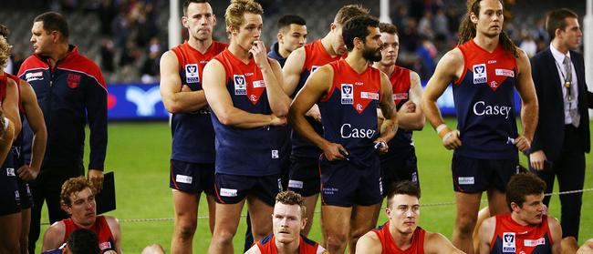 Disappointed Casey Demons players after the grand final.