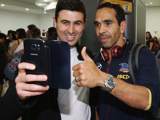 An Adelaide fan greets Eddie Betts on arrival at Melbourne Airport. Photo: Michael Dodge/Getty Images