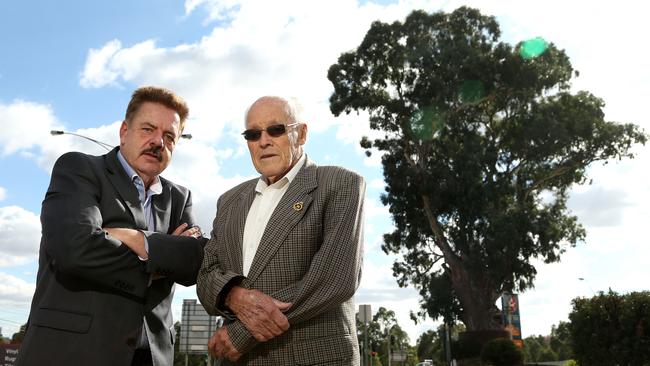 Geoff Gough and Nevin Phillips at the historic tree in Bulleen. Picture: Hamish Blair