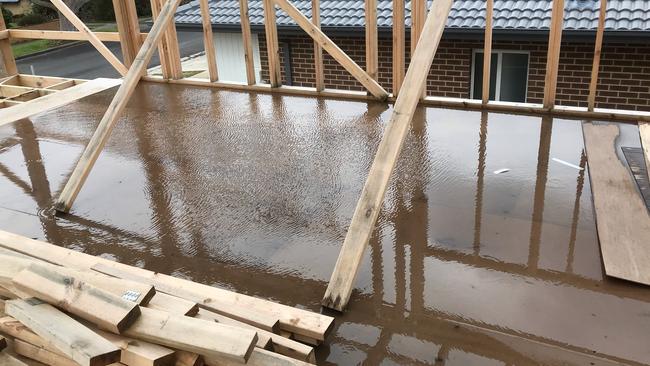 Water pools in the frame of an unfinished Langford Jones home.