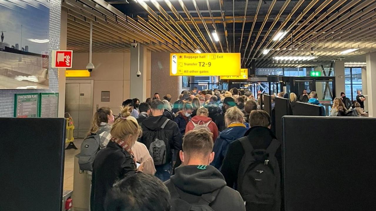 Passengers travelling from South Africa queue to be tested after being held on the tarmac at Schiphol Airport, Netherlands. Picture: Reuters.