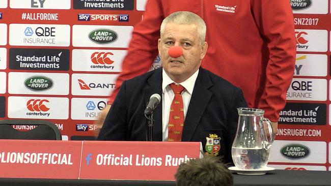 British and Irish Lions coach Warren Gatland wears a red nose during a press conference.