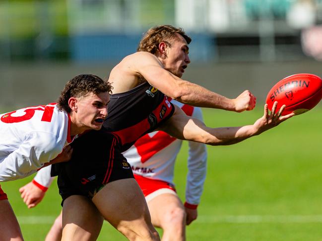 Tasmanian State League Preliminary Final between North Launceston and Clarence. Josh Rickard of North Launceston hand balls away from Willam Busch of Clarence. Picture: Linda Higginson