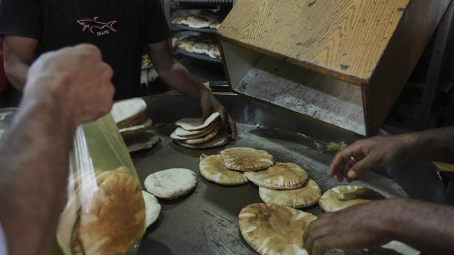 Palestinians bake bread after the World Food Program was able to bring in flour for the Gaza Strip. Picture: AP