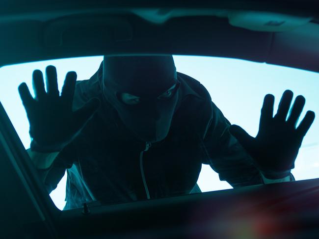 Car Robber Concept Photo. Robber Looking Thru Car Window. Carjacking Theme.