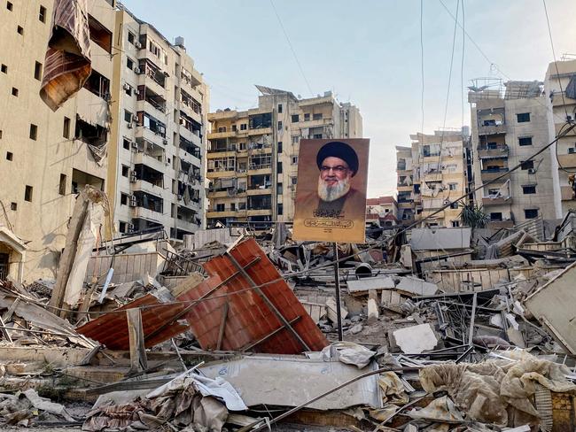 A portrait of slain Hezbollah leader Hassan Nasrallah sits amids debris at Beirut's southern suburb Rouweiss on October 10. Picture: AFP