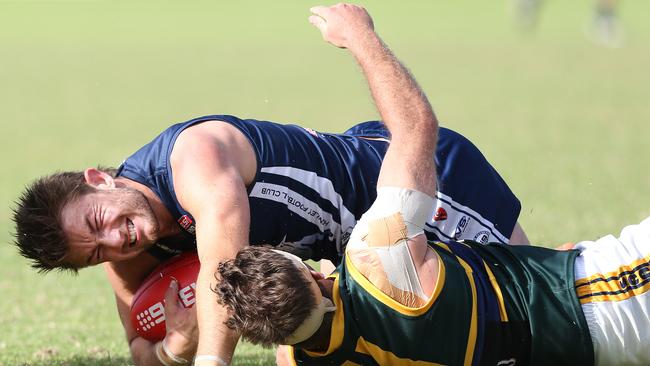 Jack Enright (Henley) is tackled by Sam Franklin (Pembroke). Picture: Stephen Laffer