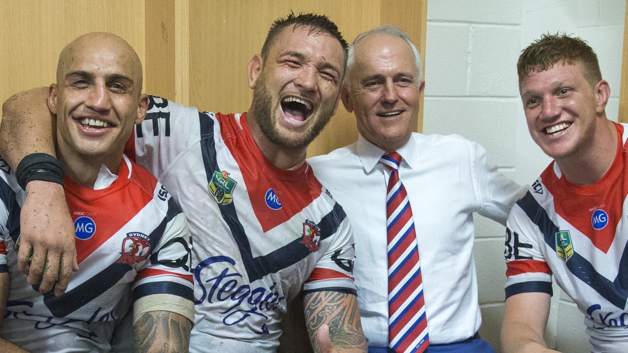 Prime Minister Malcolm Turnbull poses for a picture with the Roosters (left to right) Blake Ferguson, Jared Waerea-Hargreaves and Dylan Napa. (AAP Image/Craig Golding)