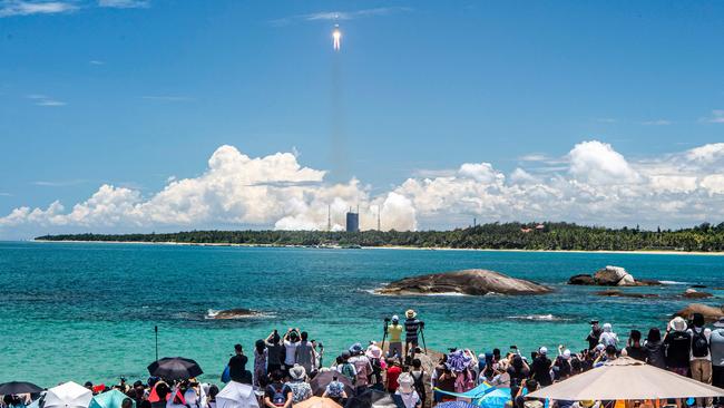 People watch the launch of a Long March-5 rocket, carrying an orbiter, lander and rover as part of the Tianwen-1 mission to Mars, lifting off from the Wenchang Space Launch Centre in southern China. Picture: AFP