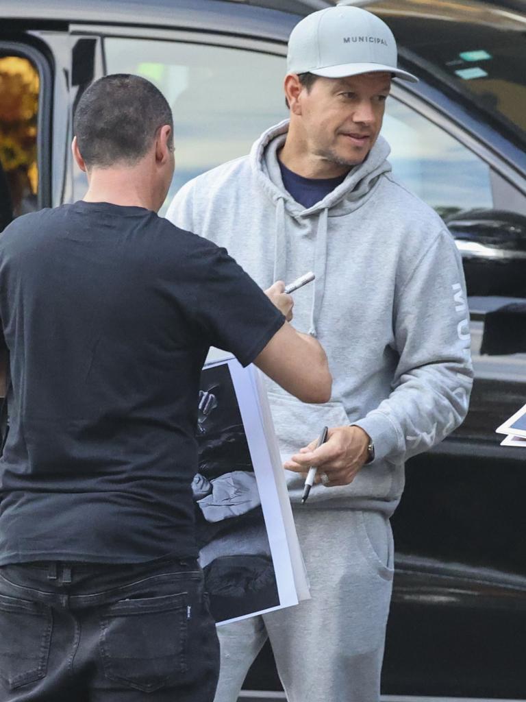 Wahlberg was spotted meeting some fans outside of the private jet terminal, signing autographs and posing for selfies. Picture: MEDIA-MODE.COM