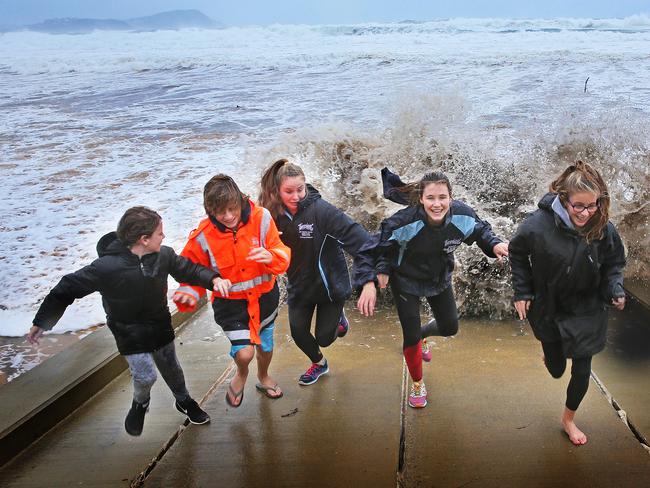 Terrigal Surf Life Saving Club nippers run from a wave as it breaks on the ramp in front of the surf club / Picture: Troy Snook