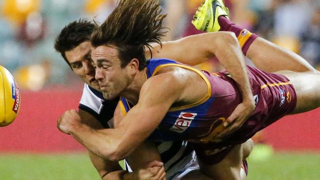 Andrew Mackie lays a heavy tackle on young Lion Rhys Mathieson. Picture: AAP