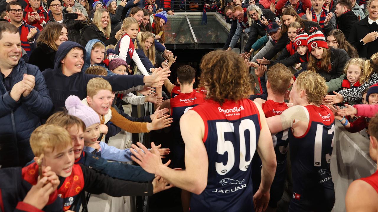 That’s nine as fans join in the celebrations as the Dees leave the field. Picture: Michael Klein