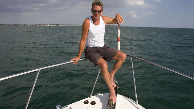 Sam Newman on the bow of his boat Sea Sea Rider on Port Phillip Bay.