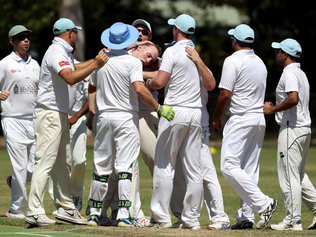 West Bentleigh players get around Nick Huttley.