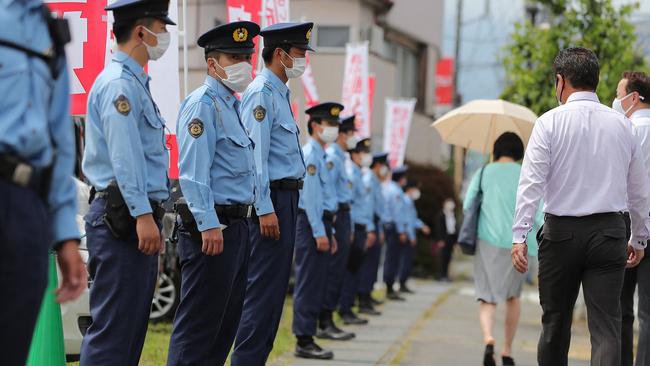 Police officers stand guard at a speech venue for an election campaign in Fujiyoshida City, Yamanashi prefecture, on the eve of polling day. Picture: AFP