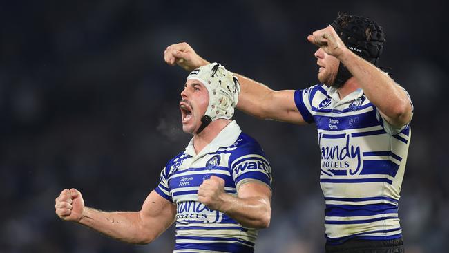 Reed Mahoney of the Bulldogs (L) and Matt Burton of the Bulldogs celebrate victory at full time during the round eleven NRL match between Bulldogs and Roosters at Accor Stadium, on May 16, 2025, in Sydney, Australia. (Photo by Mark Evans/Getty Images)