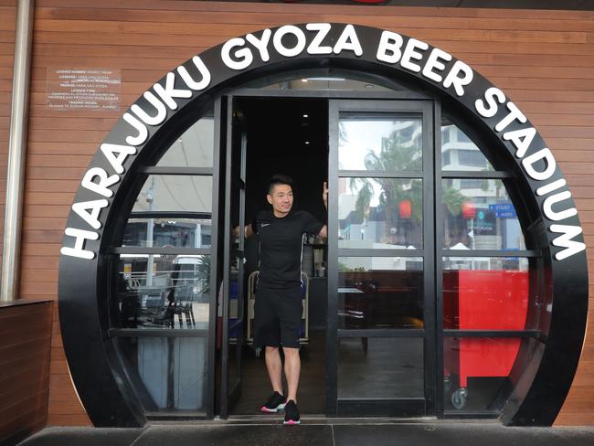 Businesses shut down in Broadbeach due to the new Coronavirus regulations. Harajuku Gyoza manager Andy Yang closes the door... Picture Glenn Hampson