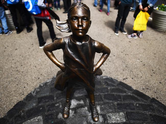 Fearless Girl stands facing the Charging Bull in New York’s Wall Street. Picture: AFP