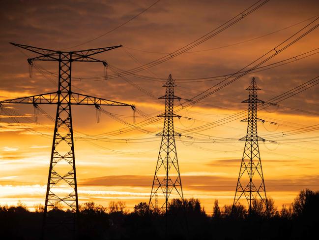 This photograph taken on December 6, 2022, shows the poles of a very high voltage power line in Verfeil, southwestern France. - France may face "some days" this winter when insufficient electricity supply could mean power cuts, the head of French energy regulator RTE said on December 1, 2022, as the government briefed local authorities on how to manage any possible outages. (Photo by Lionel BONAVENTURE / AFP)