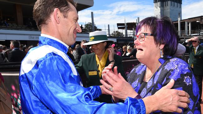 Hugh Bowman celebrates another Winx win with Debbie Kepitis in trusty purple and black dress. Picture: Getty Images