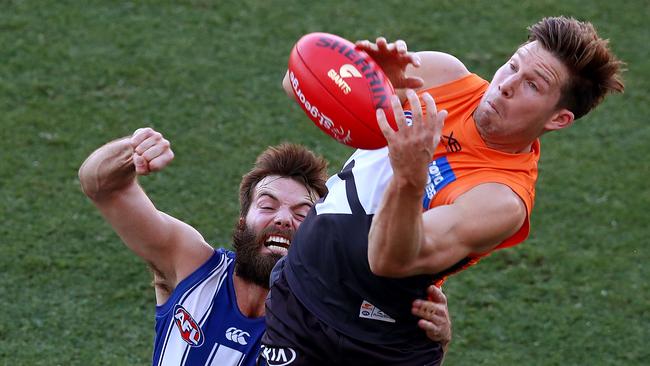 Greene marks in front of Kangaroo Luke McDonald during Round 2. Picture: Toby Zerna