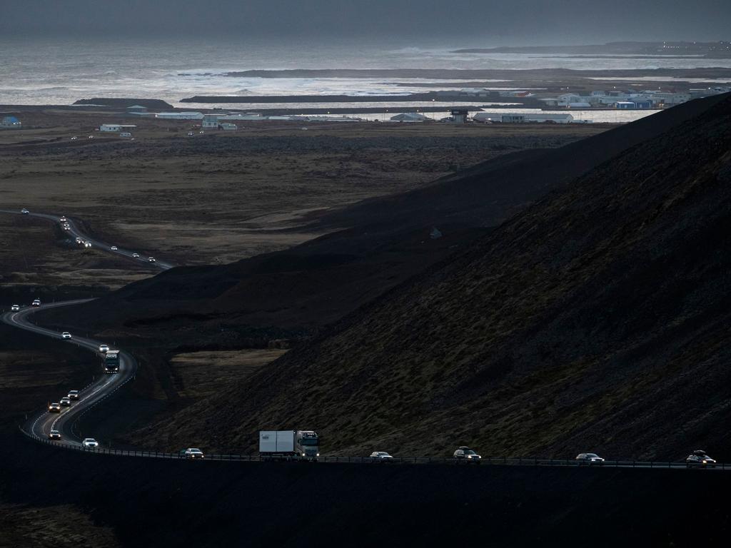 Vehicles are seen leaving the town of Grindavik on November 13. Evacuation began in the early hours of Saturday 11 November after magma shifting under the Earth's crust caused hundreds of earthquakes in what could be a precursor to a volcanic eruption. Picture: Kjartan Torbjoernsson/AFP/Iceland OUT