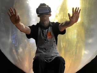 PLAYING WITH REALITY: Rockhampton Art Gallery volunteer Jarred Kennedy experiences the virtual reality headset in front of Andrew Styan's Life Support System 2016 installation. Picture: Jann Houley