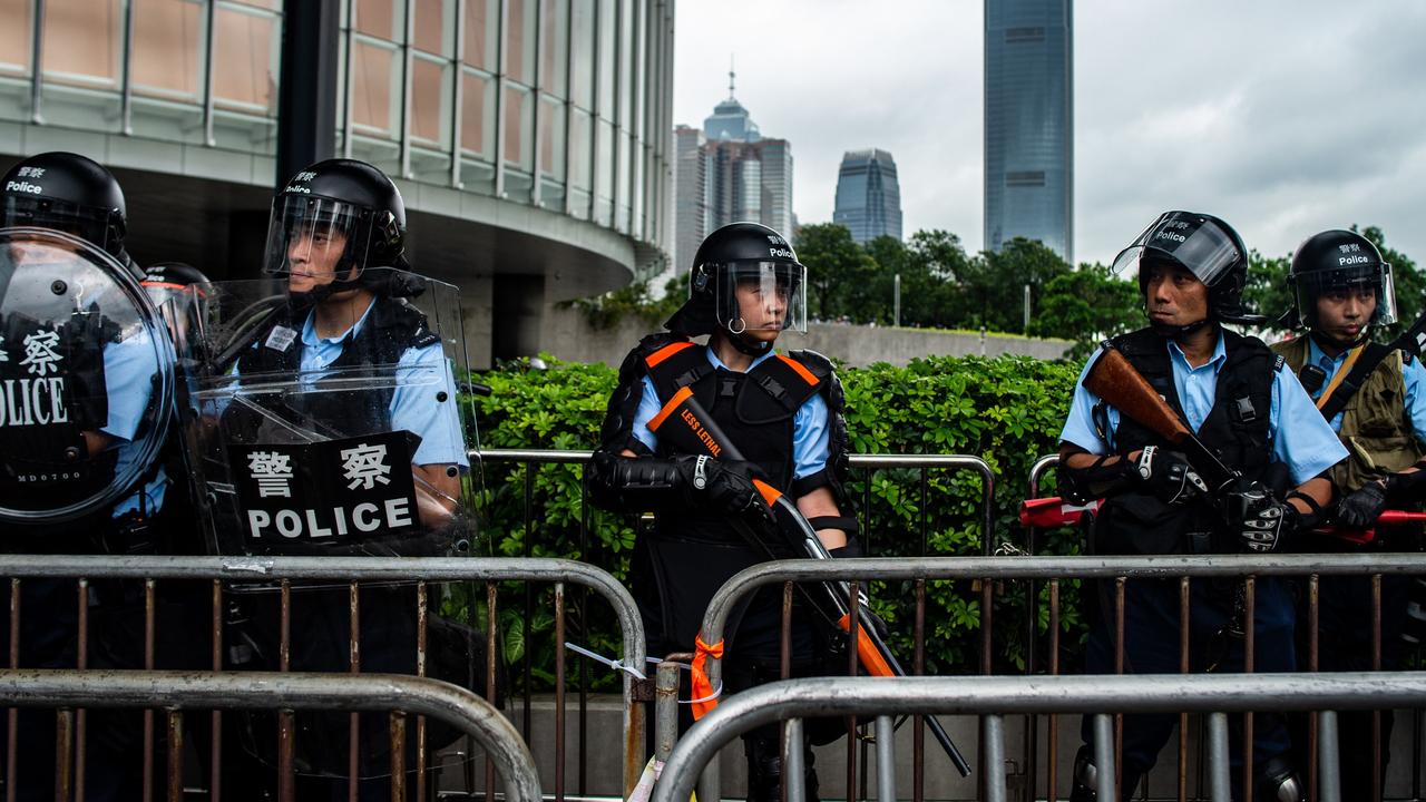 Riot police stand guard outside the Legislative Council. Picture: Philip Fong/AFP