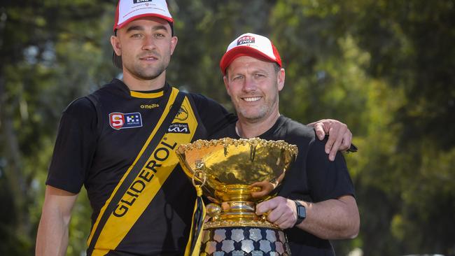 Glenelg’s Brett Turner (left) and coach Darren Reeves with the SANFL premiership cup at the West End chimney celebrations at Brickworks Marketplace on Tuesday. Picture: Roy VanDerVegt