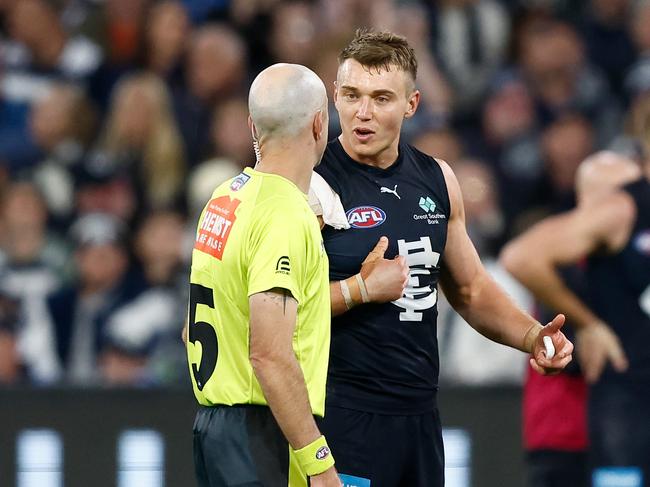 MELBOURNE, AUSTRALIA - APRIL 27: Patrick Cripps of the Blues and AFL Field Umpire, Mathew Nicholls share a discussion during the 2024 AFL Round 07 match between the Geelong Cats and the Carlton Blues at the Melbourne Cricket Ground on April 27, 2024 in Melbourne, Australia. (Photo by Michael Willson/AFL Photos via Getty Images)